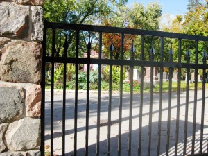 The Cemetery, padlocks on wrought iron fence, after Sundown, before Sunrise. See the stones and monuments of various ages, sizes, colors. Look at the massive old trees that are home to the birds and squirrels.